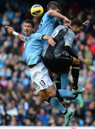 Manchester City's Aleksandar Kolarov (L) and Matija Nastasic (2nd L) vie with Tottenham Hotspur's Clint Dempsey (R)
